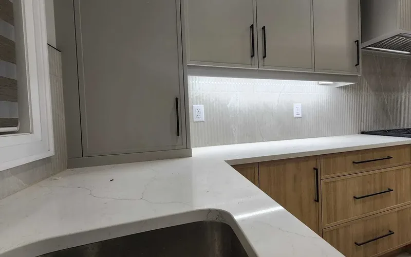 Finished suite kitchen with quartz counters, tiled backsplash and an undermount sink in a GTA renovation