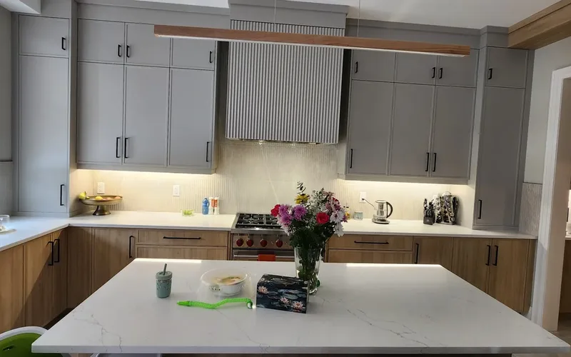Finished GTA kitchen with sink under the window, range centred on the back run and a large island
