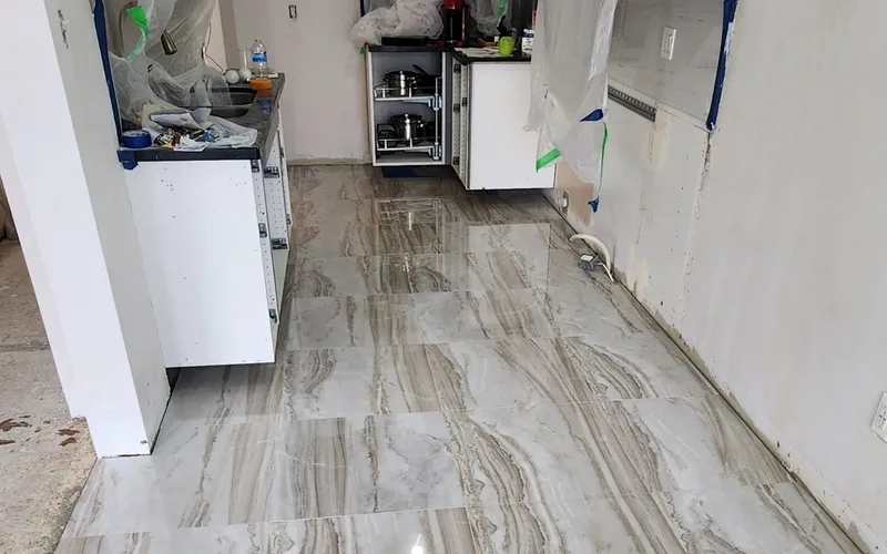 Toronto kitchen renovation in progress: cabinet boxes set, walls masked off, new floor tile down