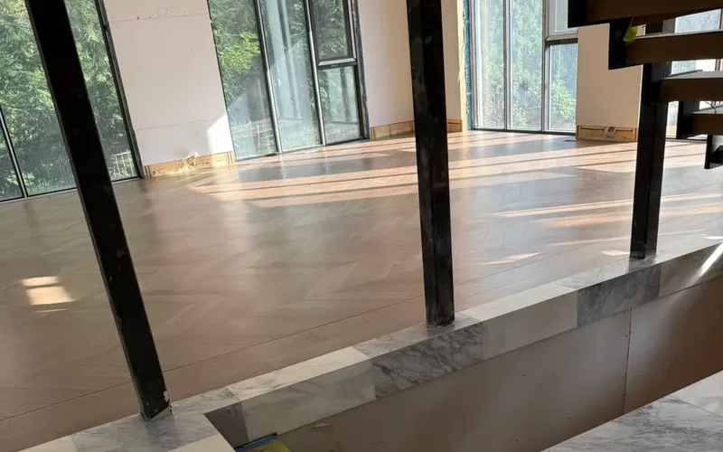 Steel posts standing in an opened-up main floor during a GTA renovation, carrying the load where walls were removed